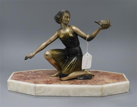 An Art Deco figure of a girl holding a dove, on marble base length 39cm